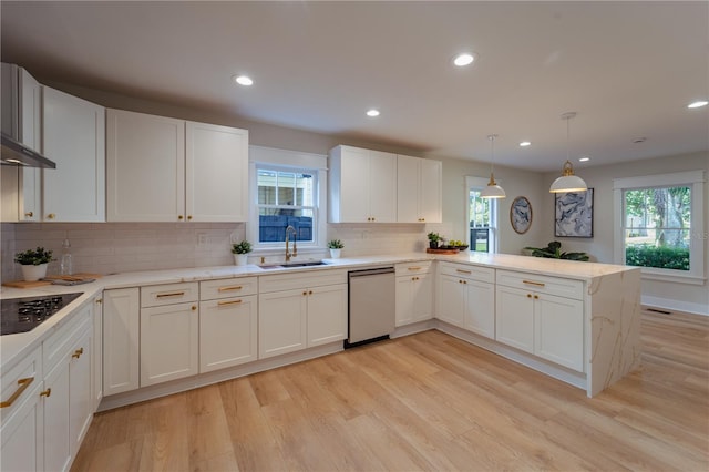 kitchen featuring white cabinets, light countertops, dishwasher, and a peninsula