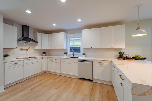 kitchen featuring pendant lighting, white cabinetry, wall chimney range hood, and stainless steel dishwasher