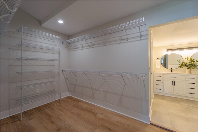 walk in closet featuring light wood-style flooring