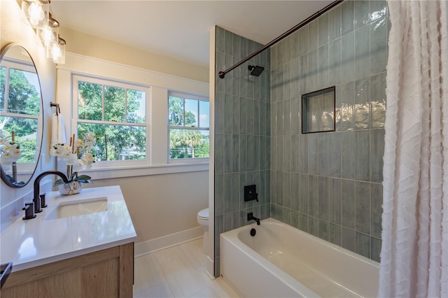 full bathroom featuring toilet, shower / bath combo, baseboards, and vanity