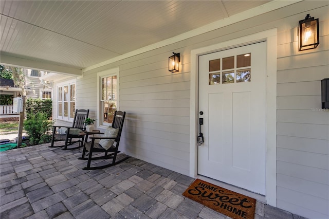 view of exterior entry with covered porch