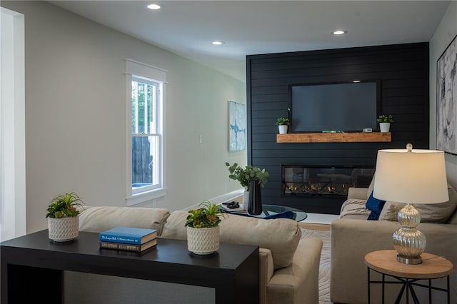 living area with a fireplace and recessed lighting