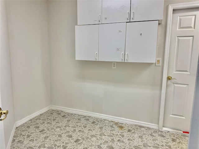 laundry area featuring baseboards