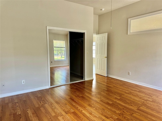 unfurnished bedroom featuring baseboards and wood finished floors