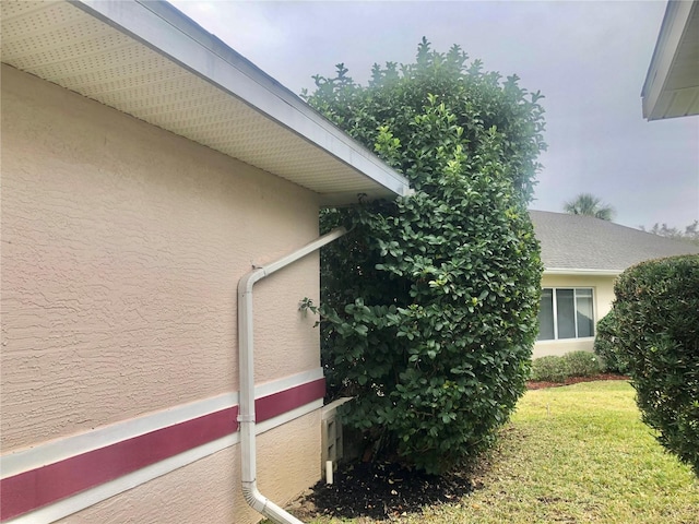 view of property exterior featuring a yard and stucco siding