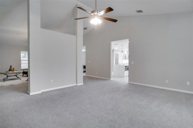 unfurnished room with ceiling fan, high vaulted ceiling, and carpet flooring