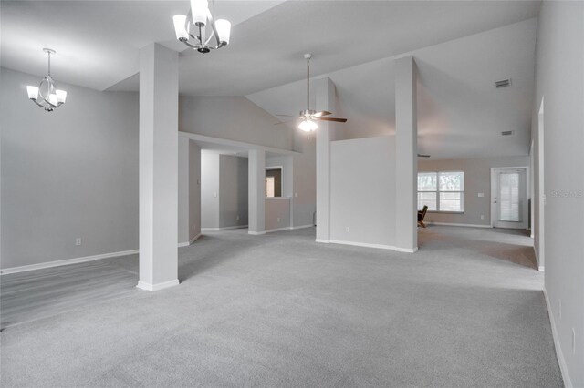 unfurnished living room with high vaulted ceiling, ceiling fan with notable chandelier, and light colored carpet