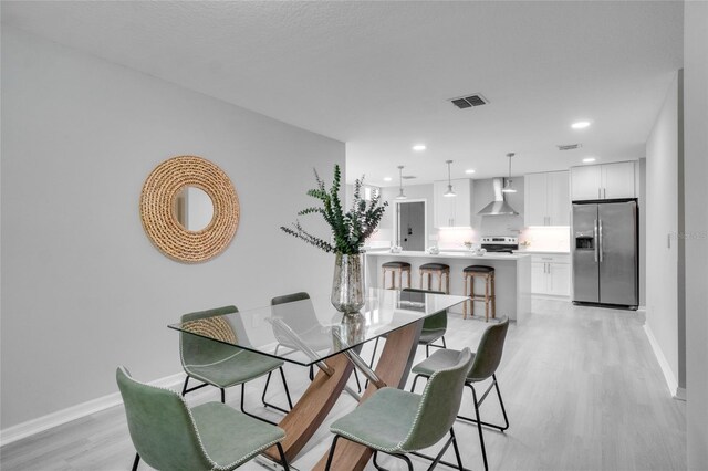 dining area with light wood-type flooring