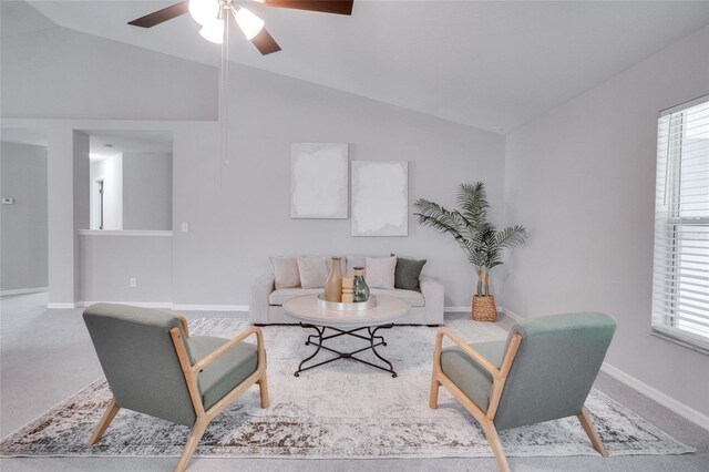 living room featuring ceiling fan, carpet flooring, and lofted ceiling