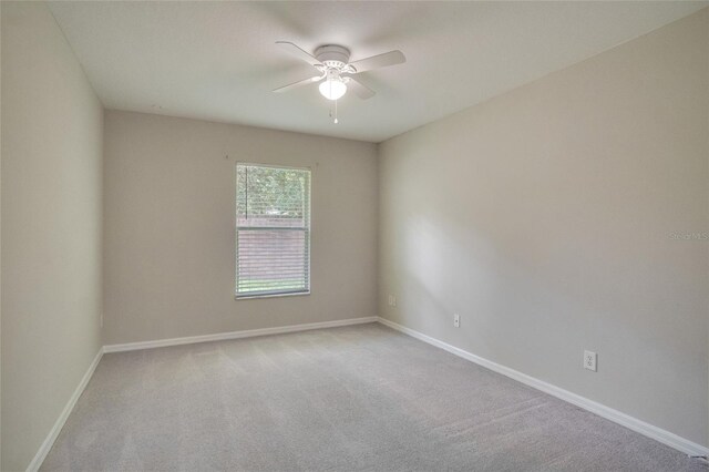 carpeted empty room with ceiling fan