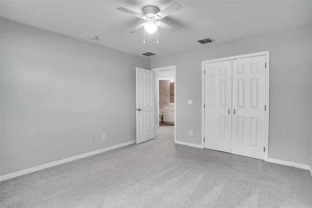 unfurnished bedroom with a closet, ceiling fan, and carpet floors