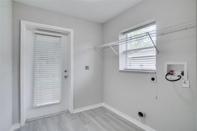 laundry area with hookup for an electric dryer, washer hookup, and light hardwood / wood-style floors