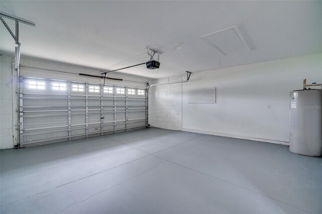 garage with a garage door opener and electric water heater