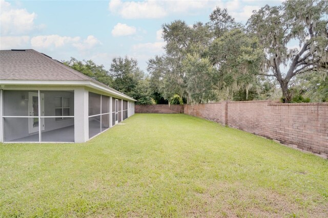 view of yard featuring a sunroom