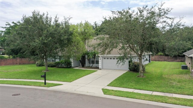 view of property hidden behind natural elements with a garage, central air condition unit, and a front lawn