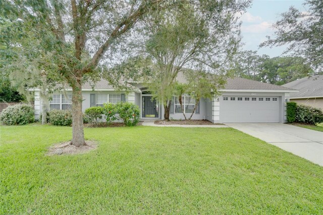 ranch-style home with a garage and a front yard