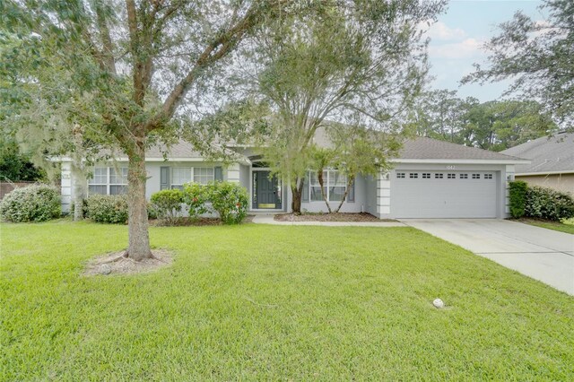 ranch-style home featuring a front lawn and a garage