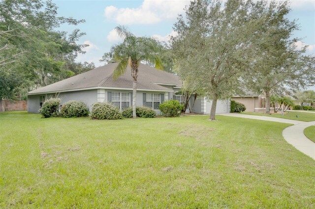 ranch-style home featuring a garage and a front yard