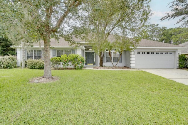 single story home with a front yard and a garage