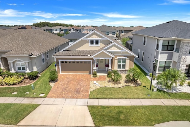 view of front of home featuring a garage and a front lawn