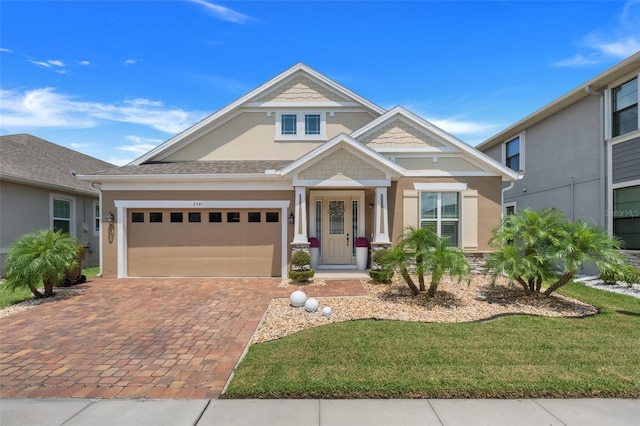 view of front of house featuring a garage and a front lawn