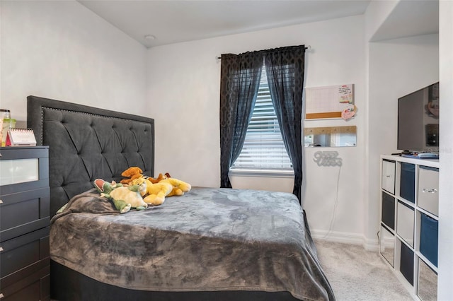 bedroom featuring light colored carpet