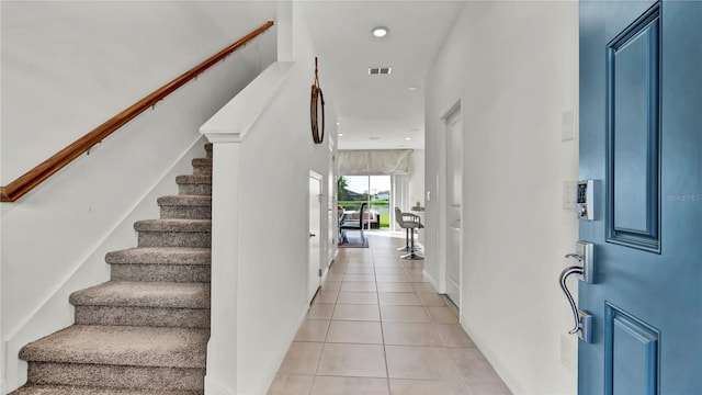 foyer featuring light tile patterned floors, stairway, visible vents, and recessed lighting