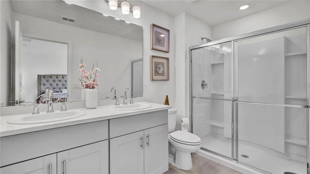 full bathroom featuring visible vents, connected bathroom, a shower stall, and a sink