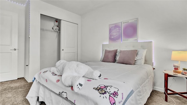 carpeted bedroom featuring baseboards and a closet