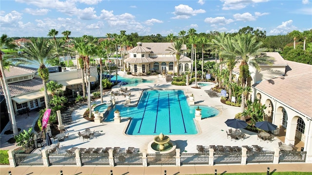 community pool featuring a patio and fence