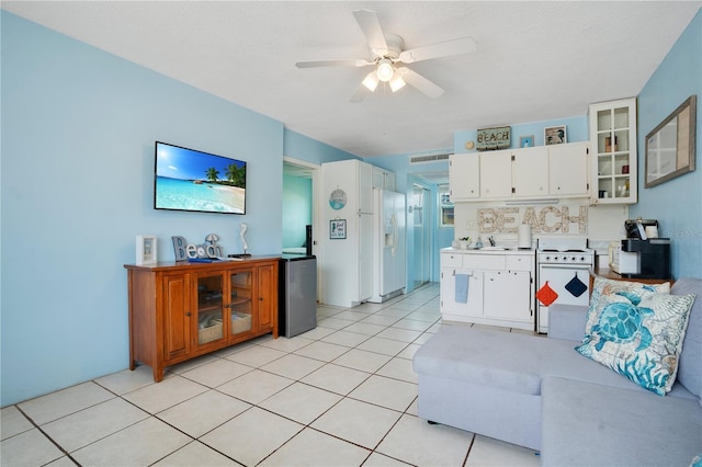 living area with visible vents, ceiling fan, a textured ceiling, and light tile patterned floors