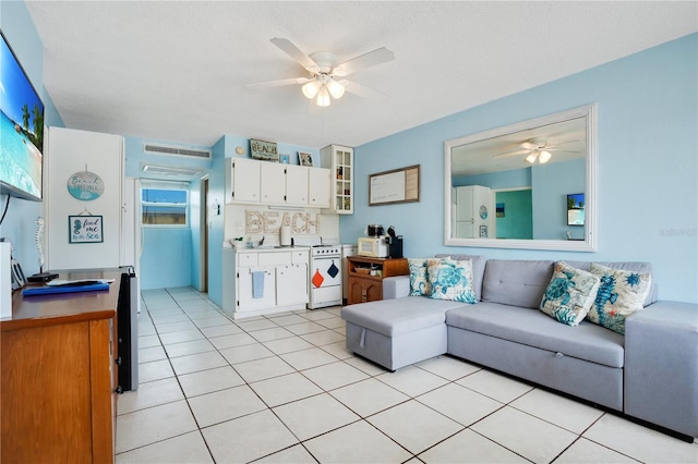 tiled living room featuring ceiling fan and a textured ceiling