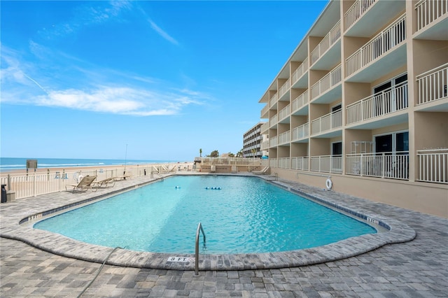 pool featuring a water view and fence