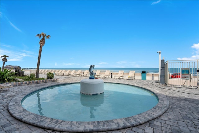 pool with a water view and fence