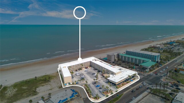 birds eye view of property featuring a beach view and a water view