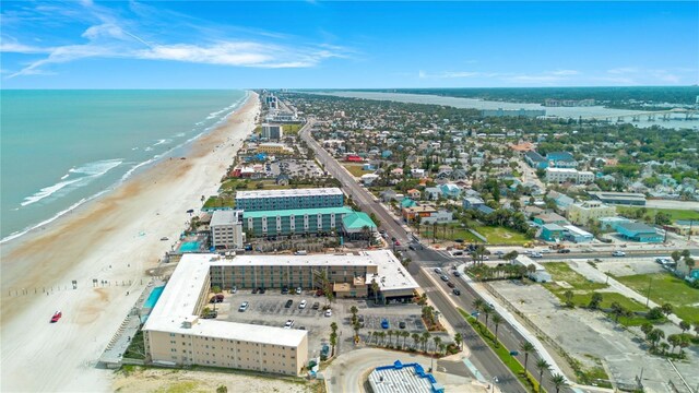 drone / aerial view with a beach view and a water view