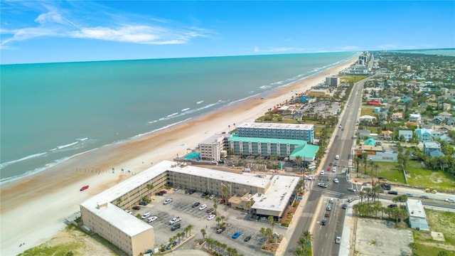 birds eye view of property with a view of the beach and a water view