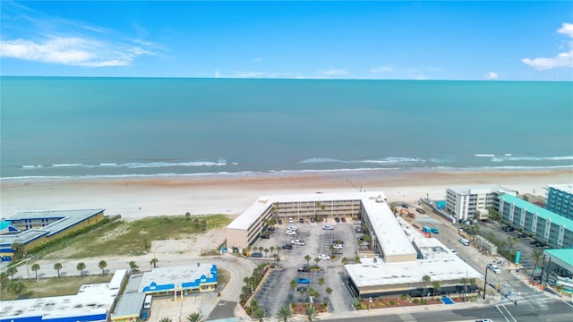 drone / aerial view with a beach view and a water view