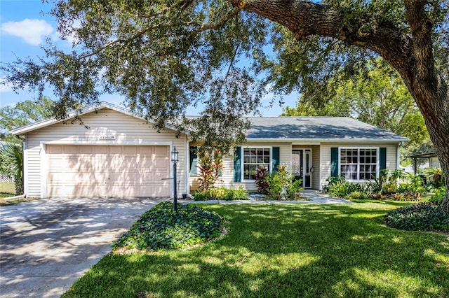 single story home featuring a garage and a front lawn