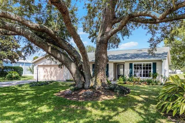 single story home featuring a front yard and a garage