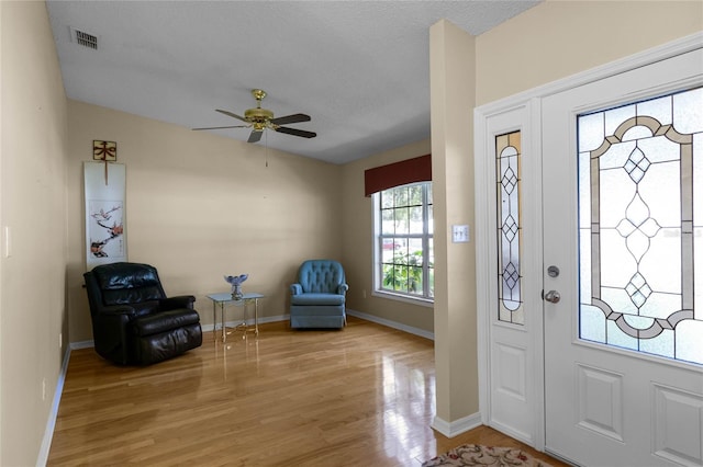 entryway featuring light wood-type flooring and ceiling fan