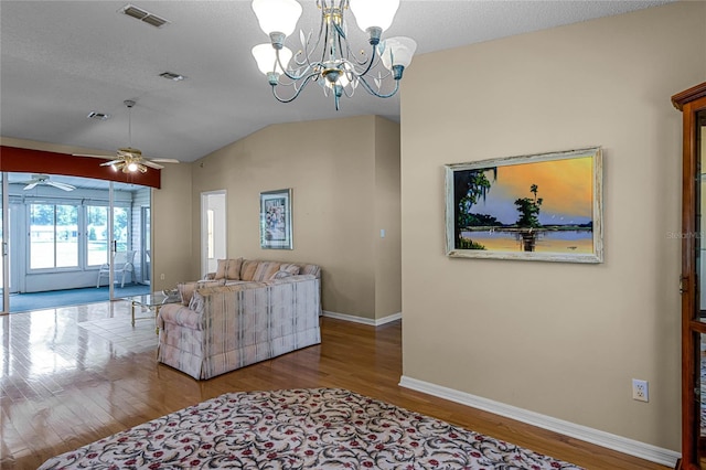 living room with hardwood / wood-style flooring, vaulted ceiling, a textured ceiling, and ceiling fan with notable chandelier