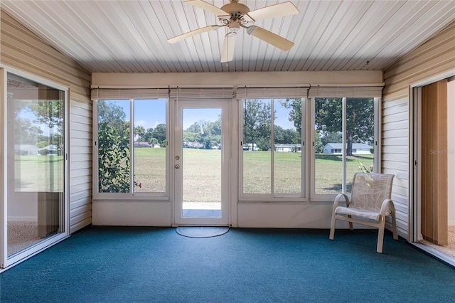 unfurnished sunroom featuring ceiling fan