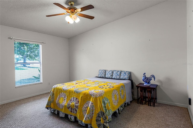 bedroom featuring ceiling fan, carpet, and a textured ceiling