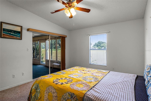 carpeted bedroom featuring ceiling fan, lofted ceiling, a closet, and multiple windows