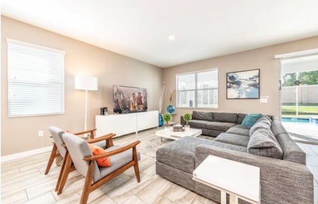 living room with a healthy amount of sunlight and light hardwood / wood-style floors