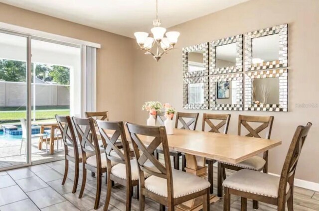 dining room featuring light tile patterned floors and a notable chandelier