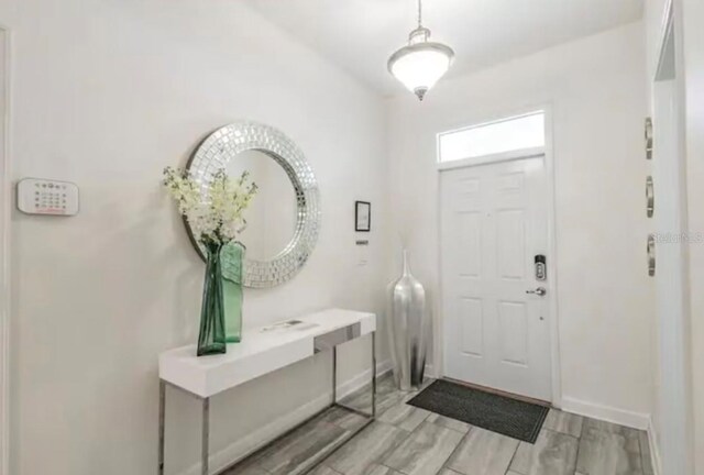 foyer entrance with light hardwood / wood-style floors