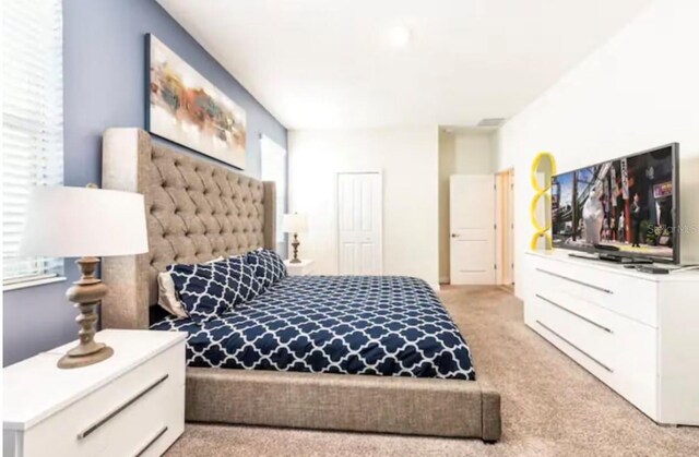 carpeted bedroom with multiple windows