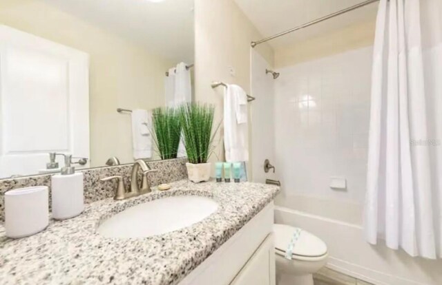 full bathroom with vanity, toilet, and shower / bath combo with shower curtain